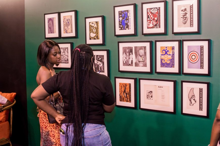 Visitors look at the display of Black Orpheus cover art at the last Art X Lagos event, curated by OlongoAfrica (November 2024)